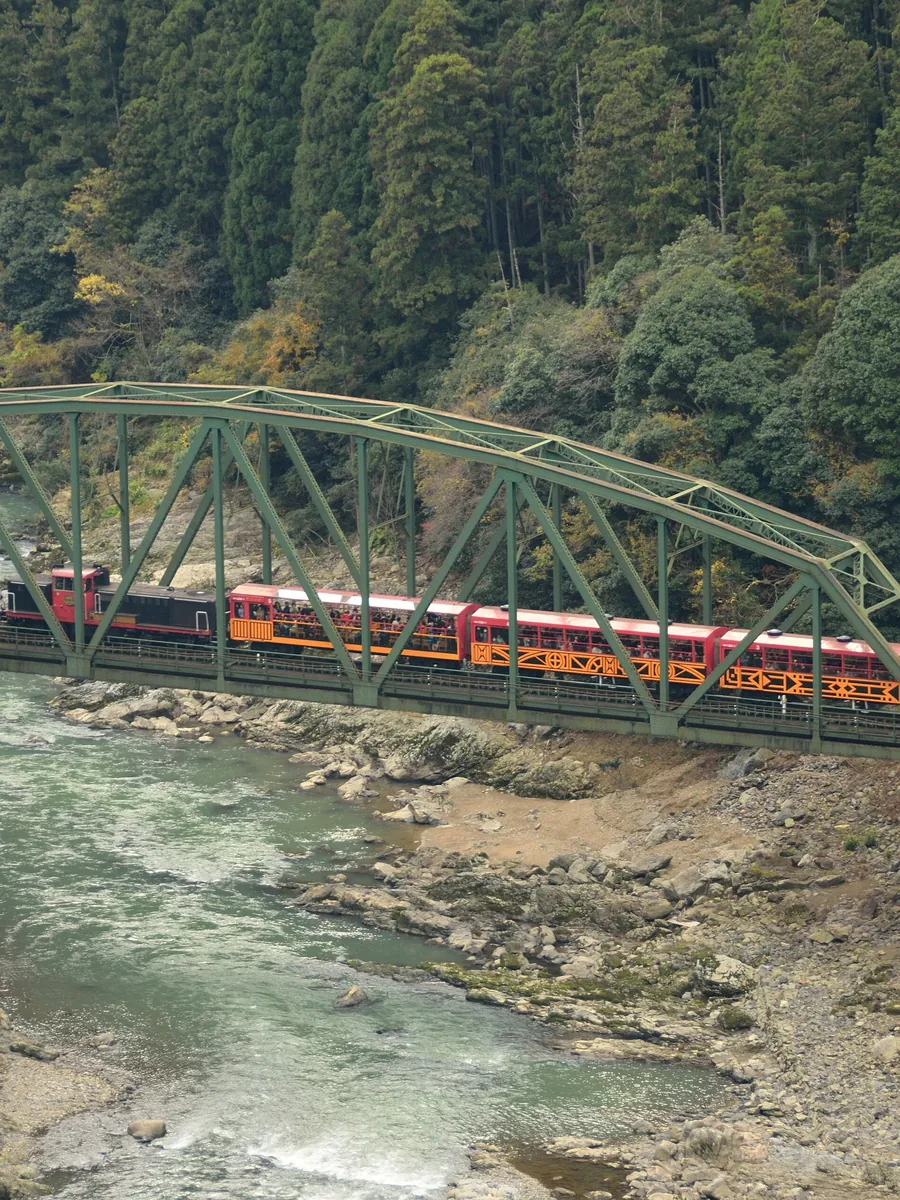 Scenic railway crossing an autumn river gorge in Japan
