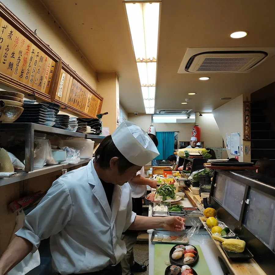 Sushi chefs at work behind the counter